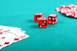 red poker gambling chips on a green playing table