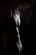 young sporty man over black background