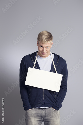 Photo: Friendly man presenting blank signboard. Friendly man presenting blank signboard.