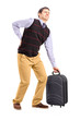 Man lifting his luggage and suffering from a back pain