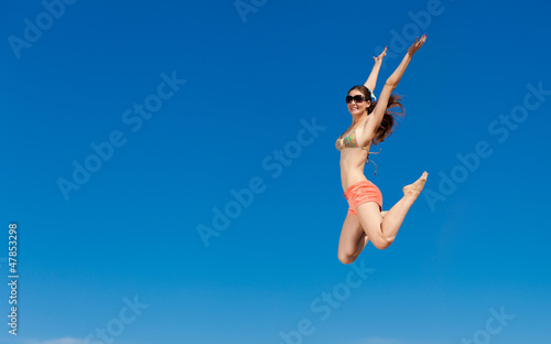 Photo: Portrait of young woman in bikini at beach Portrait of young woman in bikini at beach