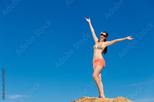 Photo: Portrait of young woman in bikini at beach Portrait of young woman in bikini at beach