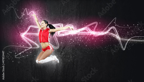 Photo: Young woman dancer. With lights effect. Young woman dancer. With lights effect.