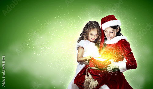 Photo: Little girl with christmas gifts and santa Little girl with christmas gifts and santa