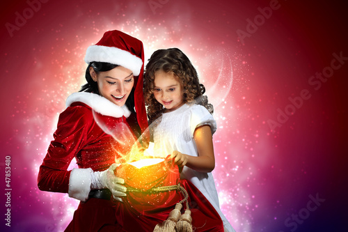 Photo: Little girl with christmas gifts and santa Little girl with christmas gifts and santa