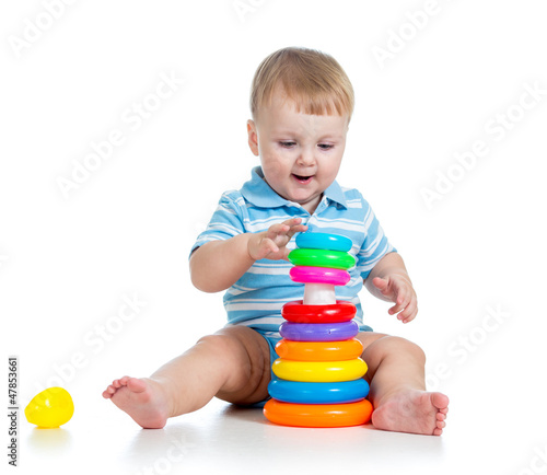 Photo: funny baby boy playing with colorful toy isolated on white funny baby boy playing with colorful toy isolated on white