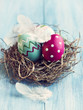 Photo: Colorful easter eggs in a nest Colorful easter eggs in a nest