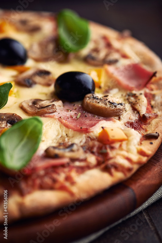 Photo: Close up of pizza with mushrooms and ham Close up of pizza with mushrooms and ham