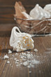 Broken meringue on wooden background