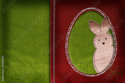 Photo: Easter bunny on textile background with space for your text Easter bunny on textile background with space for your text
