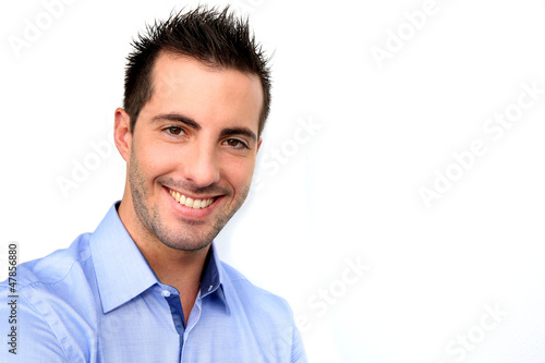 Photo: Smiling handsome guy leaning on white background Smiling handsome guy leaning on white background