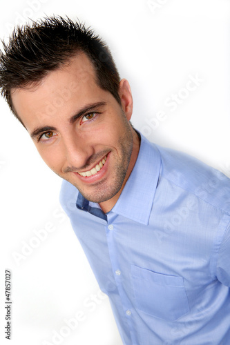 Photo: Smiling handsome guy leaning on white background Smiling handsome guy leaning on white background