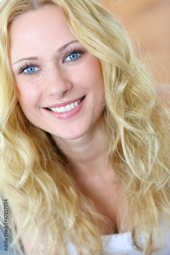 Photo: Portrait of smiling blond woman with curly hair Portrait of smiling blond woman with curly hair