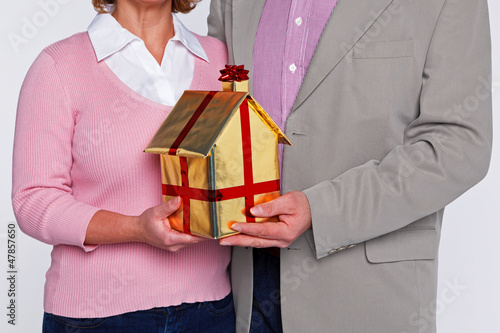 Photo: A couple holding a new home A couple holding a new home