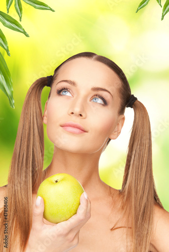 Photo: young beautiful woman with green apple young beautiful woman with green apple