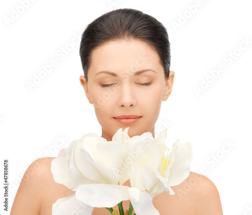 Photo: lovely woman with orchid flower lovely woman with orchid flower