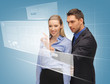 man and woman working with virtual touch screens