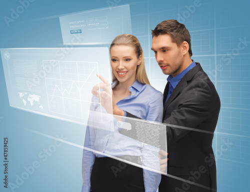 Photo: man and woman working with virtual touch screens man and woman working with virtual touch screens