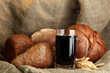 tankard of kvass and rye breads with ears, on burlap background