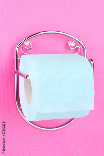 Photo: Roll of toilet paper on holder fixed to wall Roll of toilet paper on holder fixed to wall
