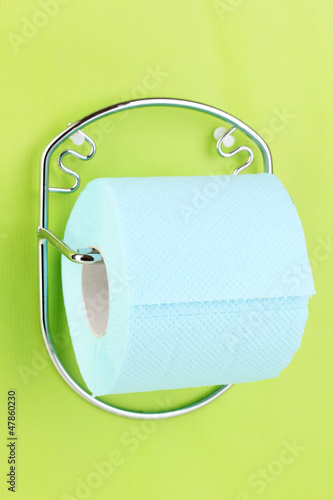 Photo: Roll of toilet paper on holder fixed to wall Roll of toilet paper on holder fixed to wall