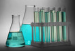 test-tubes with blue liquid on grey background