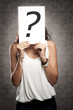 young woman holding interrogation symbol