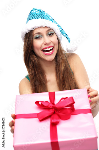 Photo: Woman in Santa hat holding Christmas present Woman in Santa hat holding Christmas present
