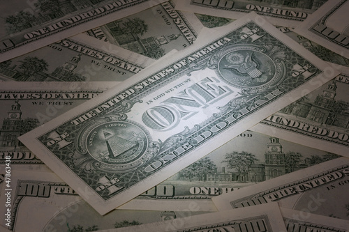 Photo: Background with American dollar bills with mysterious light Background with American dollar bills with mysterious light