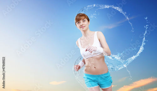 Photo: Young pretty woman in sport wear running Young pretty woman in sport wear running