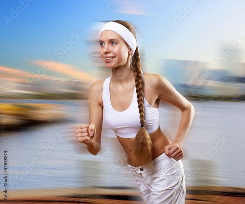 Photo: Young pretty woman in sport wear running Young pretty woman in sport wear running