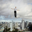 Balancing businesswoman and cityscape