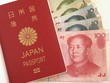 Japanese Passport and Chinese Yuan Note