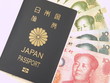 Japanese Passport and Chinese Yuan Note