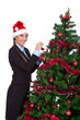 young woman decorate a christmas tree