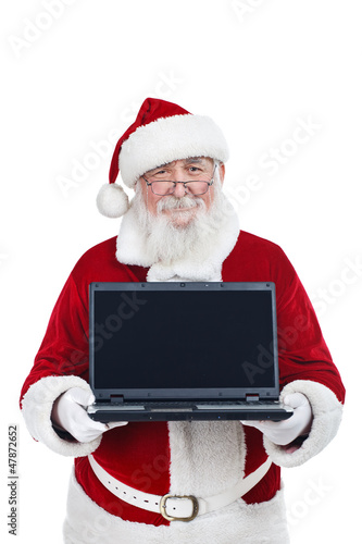 Photo: Santa Claus holding modern laptop, copy space, isolated on white Santa Claus holding modern laptop, copy space, isolated on white