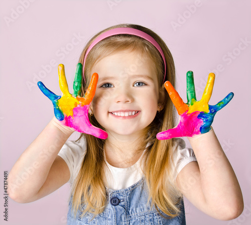 Photo: Smiling little girl with hands in the paint Smiling little girl with hands in the paint