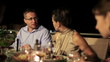 Friends eating dinner in the evening, steadicam shot