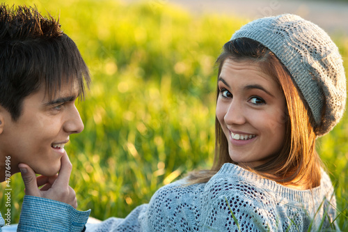 Photo: Cute teen girl laying in green grass. Cute teen girl laying in green grass.