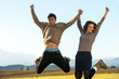 Young couple hanving fun jumping.
