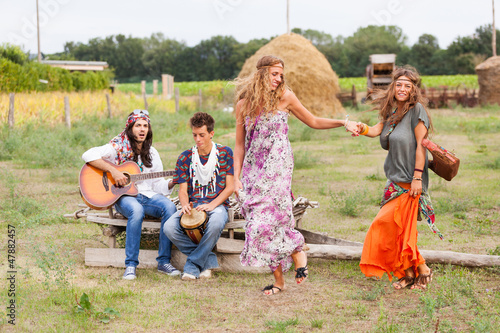 Photo: Hippie Group Playing Music and Dancing Outside Hippie Group Playing Music and Dancing Outside
