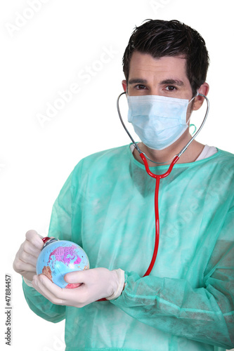 Photo: Nurse with stethoscope examining Earth Nurse with stethoscope examining Earth