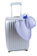 Silver suitcase with woman's hat  isolated on white
