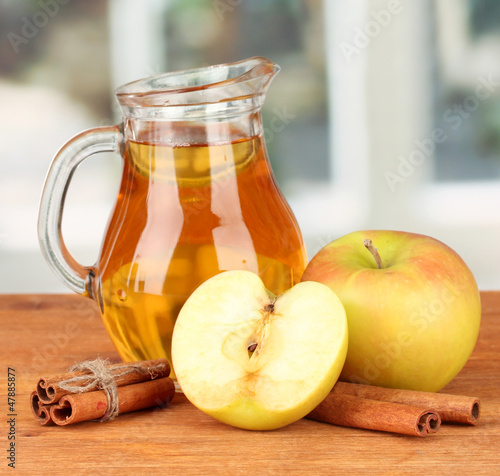 Photo: Full jug of apple juice and apple Full jug of apple juice and apple