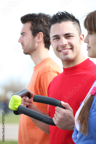 Photo: Three friends working out together outside Three friends working out together outside