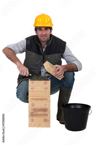 Photo: portrait of bricklayer against studio background portrait of bricklayer against studio background