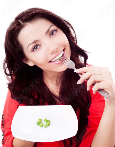 Photo: woman eating peas woman eating peas