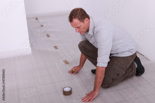 Photo: Man covering floor Man covering floor