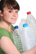 Young woman taking out the recycling