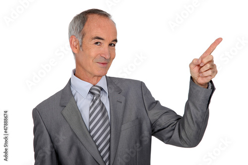 Photo: Senior man with finger up on white background Senior man with finger up on white background